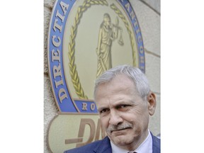 FILE - In this Friday, April 27, 2018, file picture, the leader of Romania's ruling Social Democratic party, Liviu Dragnea, looks on as he walks out of the anti-corruption prosecutors' office, in Bucharest, Romania. The High Court for Cassation and Justice said Tuesday, May 29, 2018, it would issue a first sentence on June 8 for Liviu Dragnea, chairman of the ruling Social Democratic Party as it needed more time to study the arguments submitted by the defense.