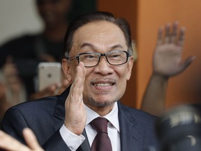 Malaysia jailed opposition icon Anwar Ibrahim waves to supporters as he leaves a hospital in Kuala Lumpur, Malaysia, Wednesday, May 16, 2018. Prime Minister Mahathir Mohamad said Malaysia's king had agreed to pardon Anwar, who was jailed in 2015 for sodomy in a conviction that he said was politically motivated.