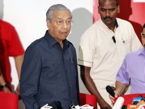 Malaysian Prime Minister Mahathir Mohamad, gesture as he arrive for a press conference to announce his cabinet members in Petaling Jaya, Malaysia, Saturday, May 12, 2018. Mahathir said Friday he will form a lean cabinet with 10 core ministries and start the process of obtaining an immediate pardon for jailed opposition icon Anwar Ibrahim.