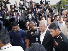 Former Malaysian Prime Minister Najib Razak, center, arrives at Malaysian Anti-Corruption Commission (MACC) Office in Putrajaya, Malaysia, Thursday, May 24, 2018. Najib appears again for questioning at the   office as part of the corruption and money-laundering investigation into the 1MDB state investment fund that Najib set up and is being investigated.