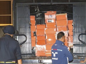 Boxes containing confiscated items are put inside a police truck in Kuala Lumpur, Malaysia Friday, May 18, 2018. Malaysian police confiscated a few hundred designer handbags and dozens of suitcases containing cash, jewelry and other valuables as part of a corruption and money-laundering investigation into former Prime Minister Najib Razak. (AP Photo)