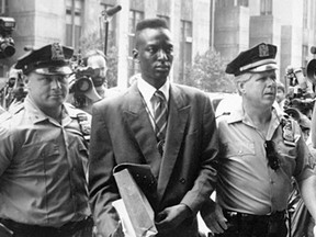 Yusef Salaam, one of the wrongly convicted Central Park Five, is escorted by New York police in a file photo from 1990.