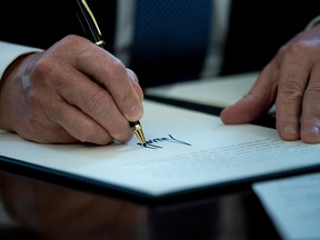 US President Donald Trump signs a business proclamation in the Oval Office of the White House October 6, 2017 in Washington, DC.