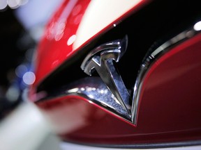 Tesla is cutting jobs as it seeks to reduce costs without endangering the critical ramp up of production of its Model 3 sedan.