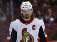 In this March 3, 2018 file photo, Ottawa Senators captain Erik Karlsson pauses on the ice during a break in play against the Arizona Coyotes.