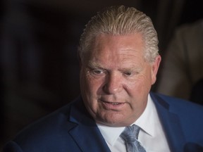 Ontario Premier-designate Doug Ford speaks to the media during a break from the first meeting of the newly-elected Ontario PC Caucus at Queen's Park in Toronto on Tuesday, June 19, 2018.