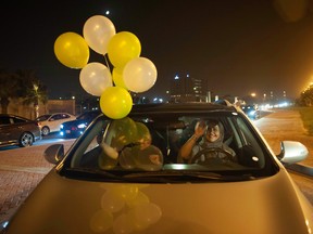 A Saudi woman and her friends celebrate her first time driving on a main street of Khobar City on her way to Kingdom of Bahrain on June 24, 2018.