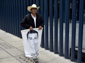 The father of one of the 43 missing students from the Ayotzinapa teachers' school participate in a press conference after a meeting with the General Prosecutor of the Republic (PGR) in Mexico City on April 14, 2016.