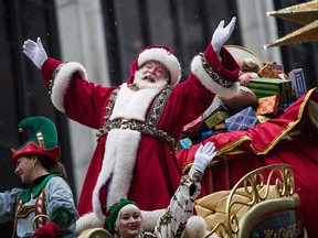 Santa Claus waves to the crowd during the Macy's Thanksgiving Day Parade on November 27, 2014 in New York City.