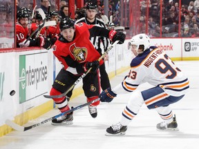 In this March 22 file photo, Ottawa Senators defenceman Cody Ceci (left) chips the puck past Edmonton Oilers forward Ryan Nugent-Hopkins.