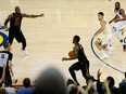 J.R. Smith of the Cleveland Cavaliers dribbles in the closing seconds of regulation as teammate LeBron James attempts direct the offence against the Golden State Warriors  in Game 1 of the NBA Finals on Wednesday night in Oakland.