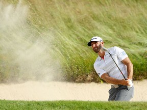 Dustin Johnson plays a shot from a bunker on the 14th hole during the first round of the 2018 U.S. Open on Thursday at Shinnecock Hills Golf Club in Southampton, N.Y.