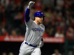 Steve Pearce of the Toronto Blue Jays celebrates after hitting a three-run homer during the ninth inning against the Los Angeles Angels on Saturday night at Angel Stadium in Anaheim, Calif.