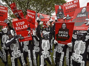 Environmental protesters demonstrate against recent government plans to mine coal and open a coal-fired power plant, in downtown Nairobi, Kenya Tuesday, June 5, 2018. Kenyan activists protested plans for the joint venture between the Kenyan and Chinese governments in Lamu County, saying it will have devastating effect on the environment and health of local populations.