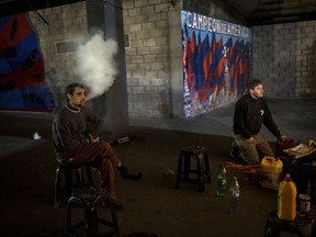 In this April 12, 2018 photo, artists and fans of the San Lorenzo soccer team, who call themselves "The artistic group of Boedo," take a break from working on a mural inside the club's stadium in Buenos Aires, Argentina. Violence has cast a shadow over Argentinean soccer in the past few decades, with at least 323 killed in clashes according to the advocacy group "Salvemos al Fútbol," or Let's Save Soccer."