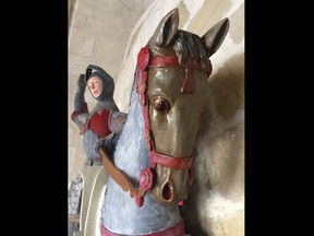 In this handout photo provided by ArtUs on Wednesday, June 27, 2018, a view of the 16th-century wooden figure of St. George, at St. Michael's Church in Estella, northern Spain, after its restoration. Spanish conservationists are outraged over what they say is yet another botched restoration of a historic work of art. The latest amateur effort to earn the disapproval of the Spanish Association of Conservator-Restorers is the restoration of a church's 16th-century wooden sculpture of a knight on horseback. The figure was recently repainted in gaudy colors by a local craftsman, instead of properly being cleaned by a professional conservationist. (ArtUs via AP)