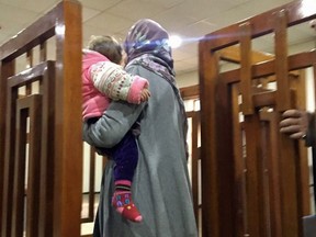 This file photo taken on February 19, 2018, shows French Jihadist Melina Boughedir carriyng her son, arriving in court in the Iraqi capital Baghdad.