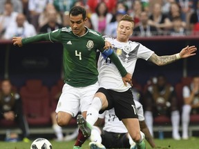 Mexico's midfielder Rafael Marquez (L) is marked by Germany's forward Marco Reus during the Russia 2018 World Cup Group F football match between Germany and Mexico at the Luzhniki Stadium in Moscow on June 17, 2018.