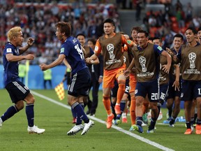 Japan's Takashi Inui, 2nd from left, celebrates with Yuto Nagatomo, left, and teammates after he scored his side's first goal during the group H match between Japan and Senegal at the 2018 soccer World Cup at the Yekaterinburg Arena in Yekaterinburg , Russia, Sunday, June 24, 2018.