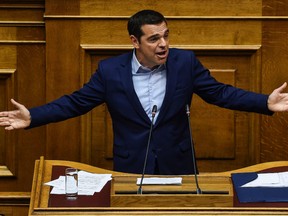 Greek Prime Minister Alexis Tsipras speaks during a parliamentary session prior the parliment vote in Athens on June 16, 2018. Greece's leftist-led government was expected to shrug off a censure vote and protests as it prepares to sign a landmark preliminary deal to end a 27-year name row with Macedonia.