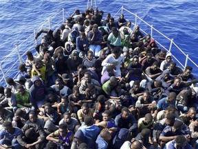 In this Sunday, June 24, 2018 photo, released by the Libyan coast guard, African migrants who were on boats in distress in the Mediterranean on their way to Europe, and rescued by the Libyan coast guard arrive to shore, east of the capital, Tripoli, Libya. Four boats, boarding 490 African migrants including 75 women and 21 children, were intercepted on Sunday off the town of Gohneima.