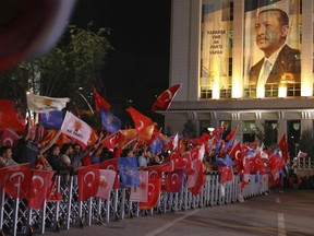 Supporters of Turkey's President and leader of ruling Justice and Development Party Recep Tayyip Erdogan celebrate outside his party's headquarters in Ankara, Turkey, late Sunday, June 24, 2018. Erdogan has claimed victory in critical elections based on unofficial results, securing an executive presidency with sweeping powers.