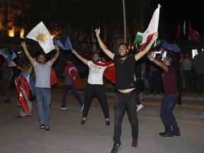 Supporters of Turkey's President and leader of ruling Justice and Development Party Recep Tayyip Erdogan celebrate outside his party's headquarters in Ankara, Turkey, late Sunday, June 24, 2018. Erdogan has claimed victory in critical elections based on unofficial results, securing an executive presidency with sweeping powers.