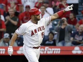 Los Angeles Angels' Albert Pujols celebrates his two-run home run against the Texas Rangers during the first inning of a baseball game in Anaheim, Calif., Friday, June 1, 2018.