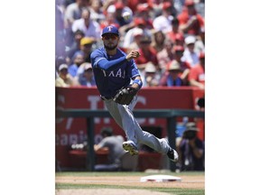 Texas Rangers third baseman Isiah Kiner-Falefa throws out Los Angeles Angels' Michael Hermosillo at first during the second inning of a baseball game Sunday, June 3, 2018, in Anaheim, Calif.