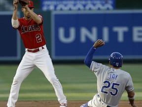 Kansas City Royals' Jon Jay, right, is forced out at second by Los Angeles Angels shortstop Andrelton Simmons on a grounder by Mike Moustakas, who was safe at first during the first inning of a baseball game in Anaheim, Calif., Tuesday, June 5, 2018.
