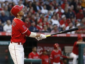 Los Angeles Angels' Andrelton Simmons hits an RBI sacrifice fly to center field to score Mike Trout during the first inning of a baseball game against the Kansas City Royals in Anaheim, Calif., Monday, June 4, 2018.