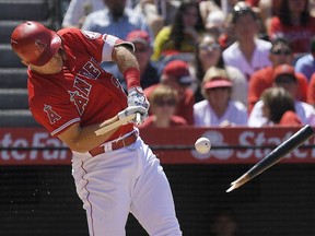 Los Angeles Angels' Mike Trout breaks his bat as he hits a single during the fifth inning of a baseball game against the Toronto Blue Jays Sunday, June 24, 2018, in Anaheim, Calif.