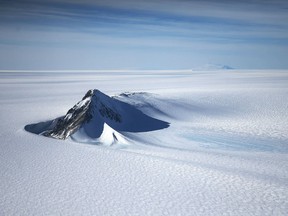 A section of the West Antarctic Ice Sheet with mountains is viewed from a window of a NASA Operation IceBridge airplane on October 28, 2016 in-flight over Antarctica. NASA's Operation IceBridge has been studying how polar ice has evolved over the past eight years and is currently flying a set of 12-hour research flights over West Antarctica at the start of the melt season.