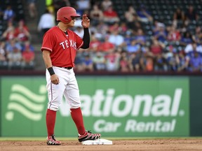 Texas Rangers' Shin-Soo Choo acknowledges the dugout after reaching second on a single by Elvis Andrus off of Chicago White Sox starting pitcher Dylan Covey during the first inning of a baseball game, Friday, June 29, 2018, in Arlington, Texas. After reaching on a first-inning lead-off walk, Choo has reached base in 41 consecutive games.