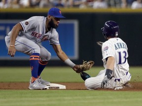 Arizona Diamondbacks' Nick Ahmed (13) is caught stealing by New York Mets Amed Rosario during the first inning of a baseball game Thursday, June 14, 2018, in Phoenix.