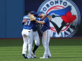 Toronto Blue Jays outfielders Teoscar Hernandez, Randal Grichuk and Kevin Pillar celebrate sweeping the Baltimore Orioles on June 10.