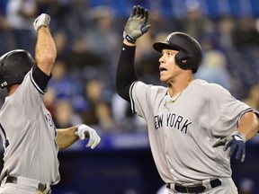 New York Yankees right fielder Aaron Judge celebrates his home run with teammate Brett Gardner  against the Blue Jays during thirteen inning  in Toronto on Wednesday.