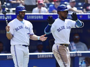 Toronto Blue Jays left fielder Teoscar Hernandez celebrates his solo home run against the Washington Nationals as Kendrys Morales looks on during eighth inning of game  in Toronto on Sunday.