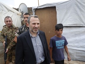 Lebanese Foreign Minister Gibran Bassil, escorted by the Lebanese army, visits a Syrian refugee camp, in Arsal, near the border with Syria, east Lebanon, Wednesday, June 13, 2018. A public spat between the Lebanese government and the United Nation's refugee agency deepened Wednesday as Lebanon's caretaker foreign minister kept up his criticism, accusing the agency of discouraging Syrian refugees from returning home. Lebanon is home to more than a million Syrian refugees, or about a quarter of the country's population, putting a huge strain on the economy.