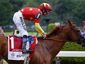 Jockey Mike Smith, reacts after crossing the finish line on Justify to win the 150th running of the Belmont Stakes horse race and the Triple Crown, Saturday, June 9, 2018, in Elmont, N.Y.