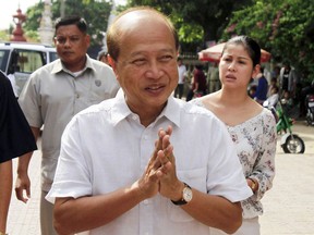 FILE - In this Sunday, June 3, 2012, file photo, Cambodian Prince Norodom Ranariddh greets people before casting his ballot in a local elections at the Wat Than temple in Phnom Penh, Cambodia.  Ranariddh, 74, has been seriously injured in a road crash that killed his wife and injured at least seven other people early Sunday.