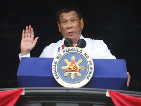 FILE - In this Tuesday, June 11, 2018, file photo, Philippine President Rodrigo Duterte gestures while addressing the crowd at the 120th Philippine Independence Day celebrations south of Manila, Philippines. President Duterte, notorious for having insulted the pope and former U.S. President Barack Obama, has sparked outrage for calling God "stupid" in Asia's bastion of Catholicism.