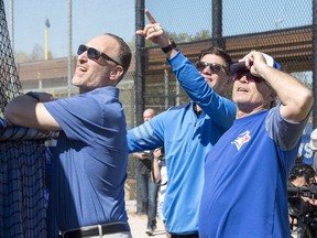 In this Feb. 19 file photo, Toronto Blue Jays (left to right) president Mark Shapiro, GM Ross Atkins and manager John Gibbons keep an eye on the action at spring training in Dunedin, Fla.