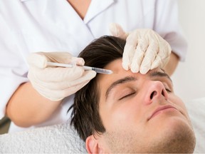 Young man having Botox treatment at beauty clinic. Men are only a tiny piece of the medical aesthetics market. They received nearly 470,000 injections of wrinkle-smoothing toxins in 2017, compared to more than 7.2 million in women, according to the American Society of Plastic Surgeons.