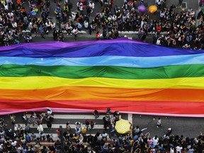 Revelers extend a flag during the annual gay pride parade in Sao Paulo, Brazil, Sunday, June 3, 2018.