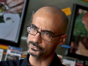In this Sept. 3, 2013 photo, Pulitzer Prize winning author Junot Diaz pauses during an interview in New York. Three editors at the Boston Review are resigning over the political and literary magazine's decision to retain Diaz despite allegations of sexual misconduct. Poetry editors Timothy Donnelly, Barbara Fischer and Stefania Heim said on Twitter last week they're "dismayed" at the logic behind keeping Diaz as fiction editor and felt compelled to step down, effective July 1.