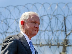 FILE - In this April 21, 2017 file photo, with razor wire across the top of the secondary border fence behind him, U.S. Attorney General Jeff Sessions attends a news conference at the U.S.-Mexico border next to the Brown Field Border Patrol Station in San Diego.  Immigration judges generally cannot consider domestic and gang violence as grounds for asylum, U.S. Attorney General Jeff Sessions said Monday, June 11, 2018 in a ruling that could affect large numbers of Central Americans who have increasingly turned to the United States for protection.