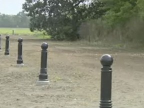 In this image taken from video, burial grounds for slaves are located in the wooded area in New Orleans, Wednesday, June 13, 2018. The Shell Oil Company has spruced up, marked and blocked off tracts of its land in the Convent community west of New Orleans where archaeologists confirmed the presence of slave burial grounds in 2013. (AP Photo)