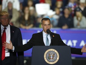 FILE - In this April 28, 2018 file photo, President Donald Trump, left, watches as Corey Lewandowski, right, his former campaign manager for Trump's presidential campaign, speaks during a campaign rally in Washington Township, Mich. Lewandowski has created a stir by dismissing a story about a girl with Down syndrome with a sarcastic "Wah wah." Lewandowski appeared Tuesday, June 19, 2018, on Fox News Channel to discuss the president's hard-line immigration policy, which has led to the practice of taking migrant children from parents charged with entering the country illegally.