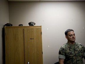 In this May 16, 2018 image, Marine Chief Warrant Officer David Coan, 35, looks out from his desk in Camp Pendleton, Calif. Coan has applied to be a part of a new cyber force after serving 17 years in the Marine Corps. The Marine Corps is considering offering bonuses to woo older, more experienced Marines to re-enlist and join its cyber operations to defend the nation, especially against cyberattacks from Russia and China.